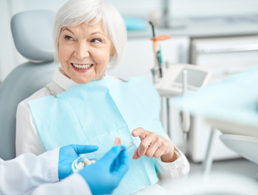 Smiling elderly woman looking at her doctor stock photo